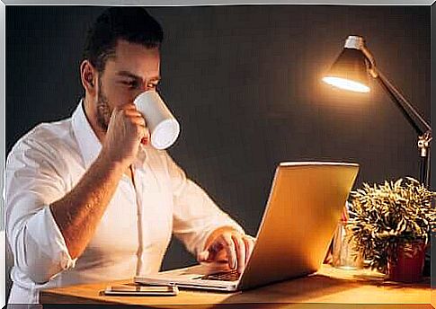 Man working from home with coffee in hand