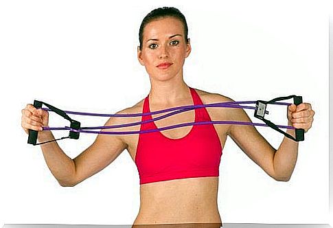 Woman standing with a training elastic