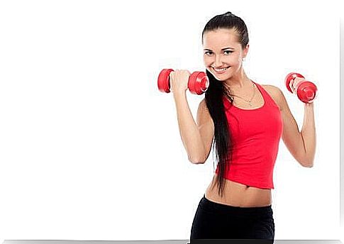 Woman standing with dumbbells