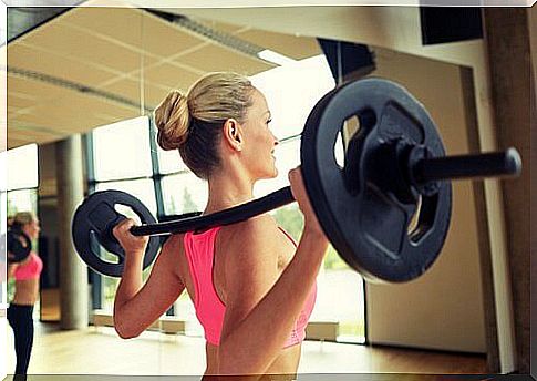 Woman doing squat with barbell