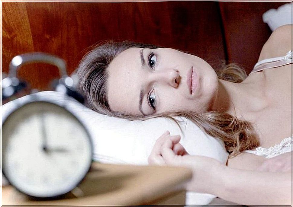 Woman staring at the alarm clock