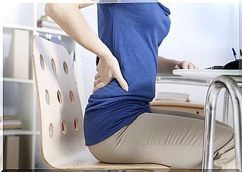 Woman sitting with back pain