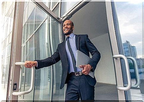 Businessman in suit opens door