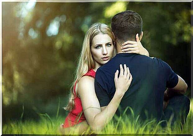 Woman hugging man on lawn