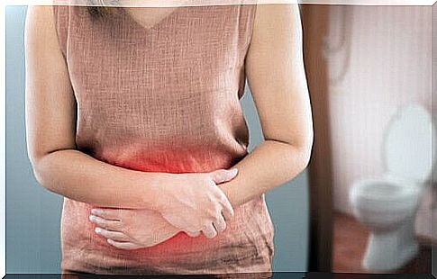 Woman in pink top holding on to belly