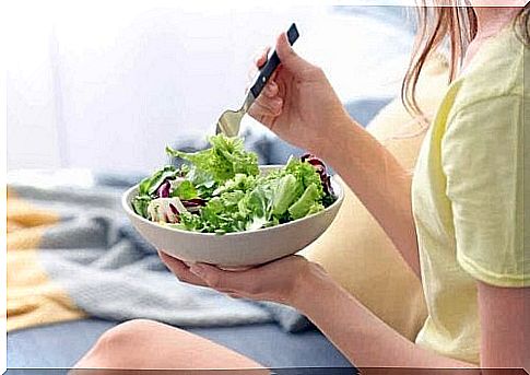 Woman eating salad