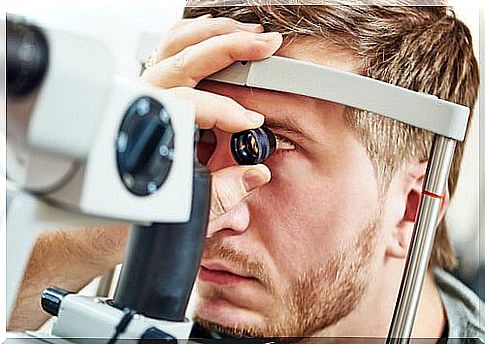 Man examining his eyes